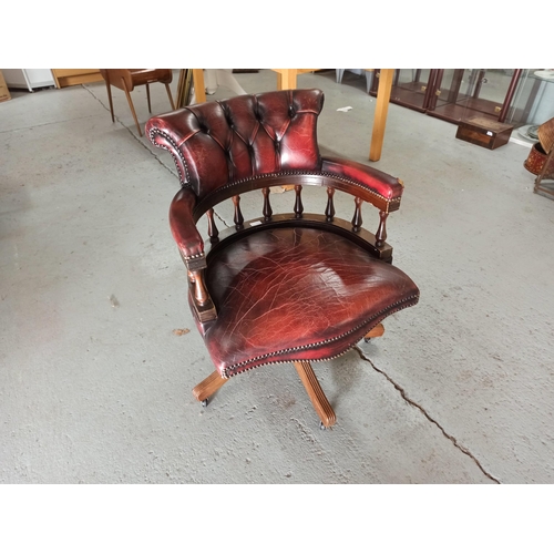 616 - A Red Leather Captains Chair on tilt and turn base. (Leather worn/torn as pictured)