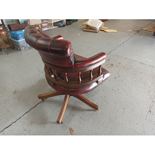 616 - A Red Leather Captains Chair on tilt and turn base. (Leather worn/torn as pictured)