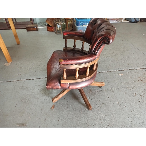 616 - A Red Leather Captains Chair on tilt and turn base. (Leather worn/torn as pictured)