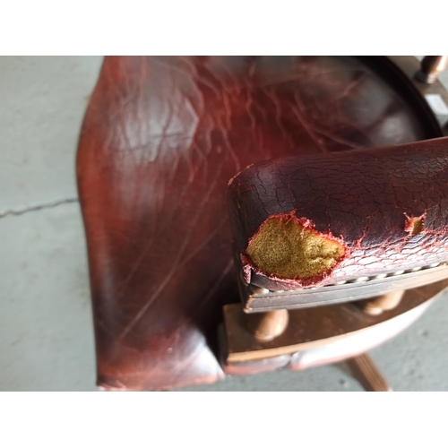 616 - A Red Leather Captains Chair on tilt and turn base. (Leather worn/torn as pictured)