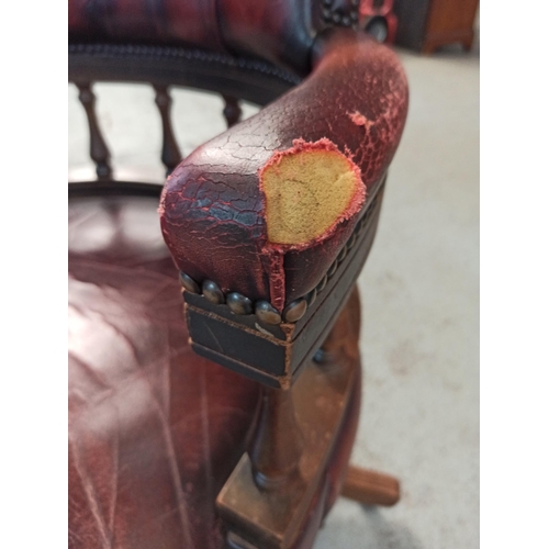 616 - A Red Leather Captains Chair on tilt and turn base. (Leather worn/torn as pictured)