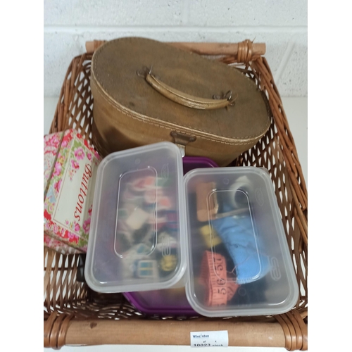 695 - A Wicker Sewing Basket and contents, buttons, patches, needle work items