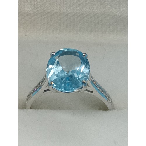 431 - A 9ct Yellow Gold Ring with large Blue Topaz Sone and diamonds to the shoulders, Size N/O