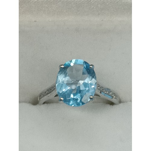 431 - A 9ct Yellow Gold Ring with large Blue Topaz Sone and diamonds to the shoulders, Size N/O