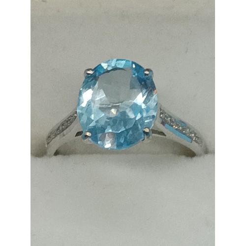 431 - A 9ct Yellow Gold Ring with large Blue Topaz Sone and diamonds to the shoulders, Size N/O