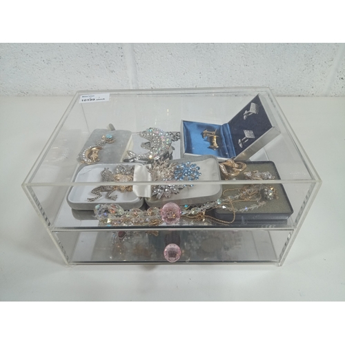 799 - A Perspex Jewellery box and contents