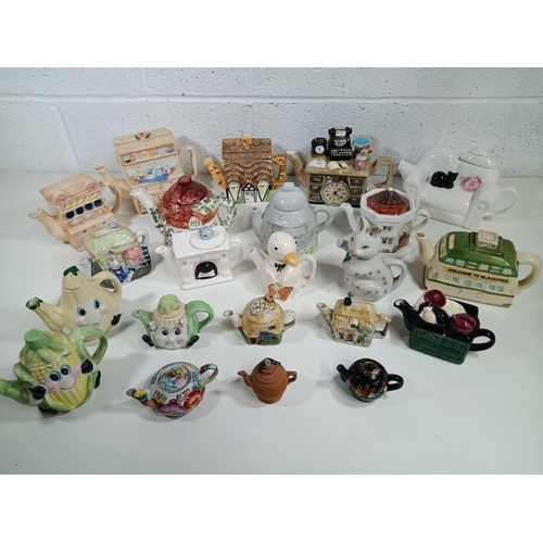 868 - A Collection of Novelty Teapots