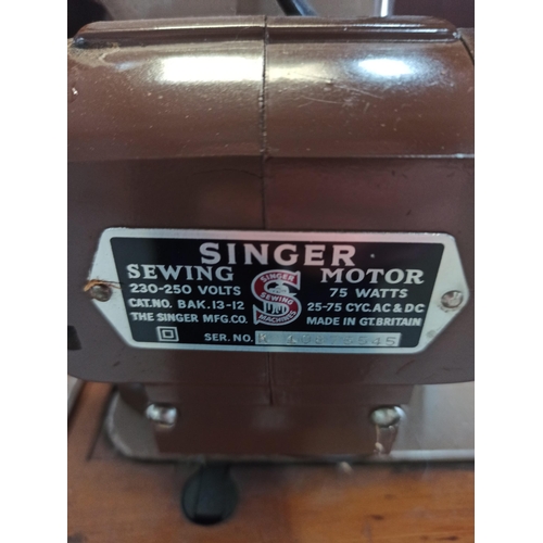 697 - A Singer Sewing Machine with side tray and leather case