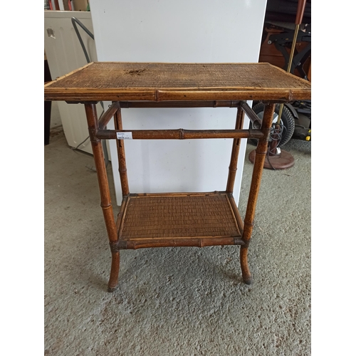 377 - A Vintage Bamboo and Rattan Table with lower shelf and metal banding