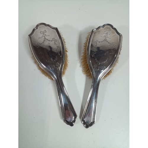 482 - A pair of engraved hallmarked silver vanity brushes