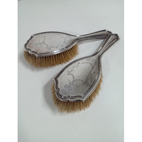 482 - A pair of engraved hallmarked silver vanity brushes