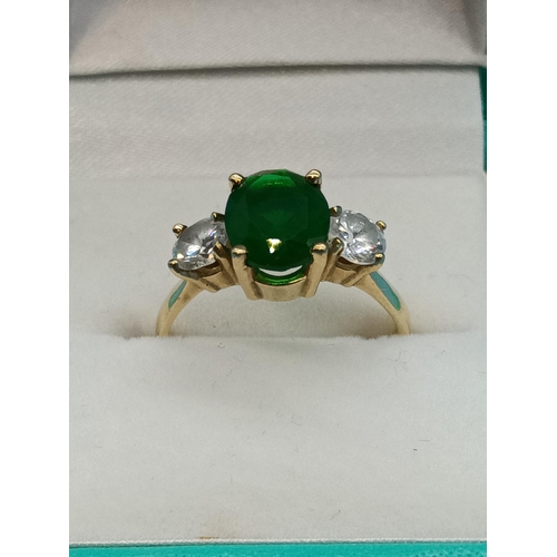 411 - A Hallmarked 9ct Yellow Gold Ring with Large Central Green Stone and Clear White Stones to Shoulders