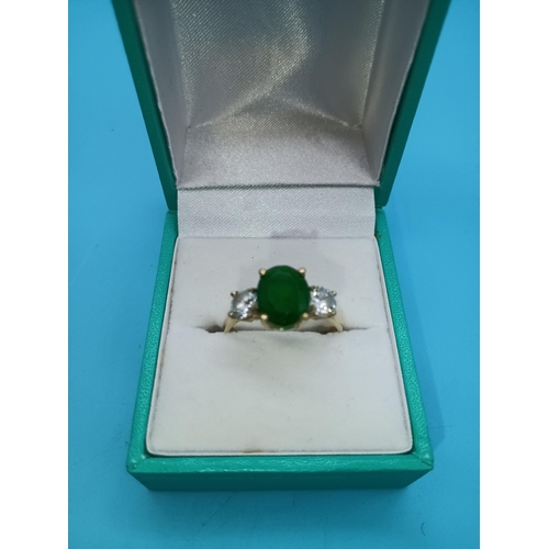 411 - A Hallmarked 9ct Yellow Gold Ring with Large Central Green Stone and Clear White Stones to Shoulders