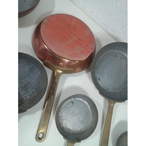 635 - A Set of Graduating Brass and Copper Pans