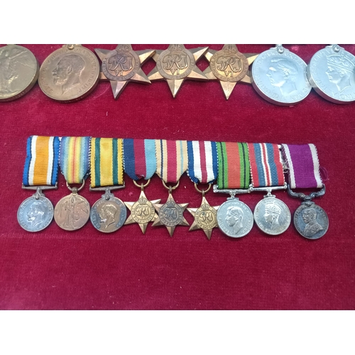 390 - A WW2 Medal Group and Miniatures. Framed. War Medal, Defence Medal, France and Germany Star, Africa ... 