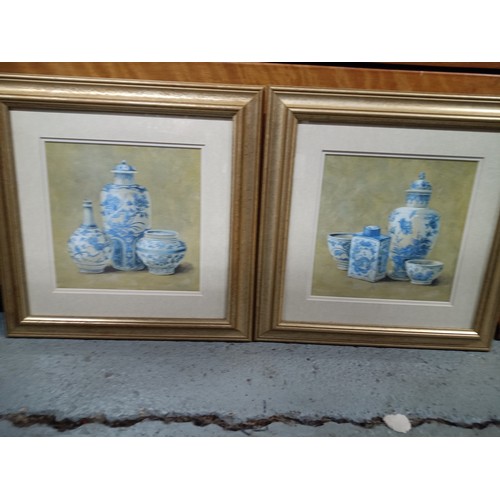 780A - A Pair of gilt framed prints of Blue and White Chinese Ginger Jars