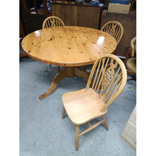 976 - A Pine Pedestal Table and 3 x 122cm Diameter Cartwheel Chairs