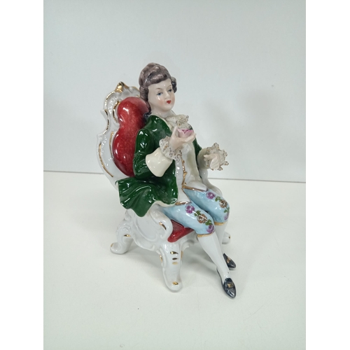 862 - A Vintage Porcelain Figurine of a Seated Regency Man holding a Rose