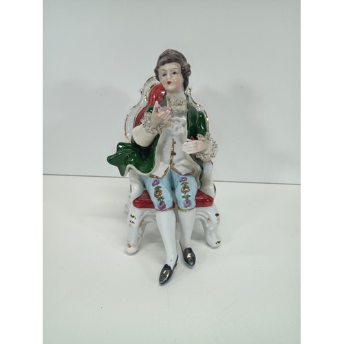 862 - A Vintage Porcelain Figurine of a Seated Regency Man holding a Rose