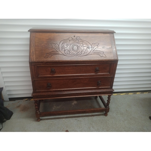 858 - An Oak Bureau with Carved Front, Barley Twist Legs and a Leather Writing Top 108cm H x 96cm W x 46cm... 