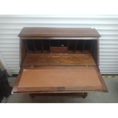 858 - An Oak Bureau with Carved Front, Barley Twist Legs and a Leather Writing Top 108cm H x 96cm W x 46cm... 