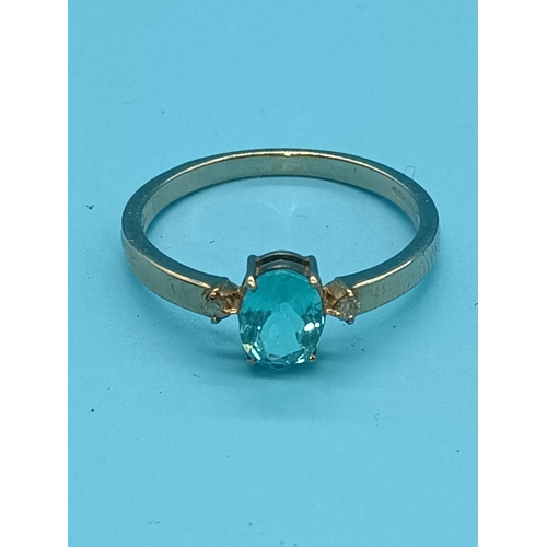 448 - A 9ct White Gold and Blue Topaz with Diamond Accents 1.55gms Size O