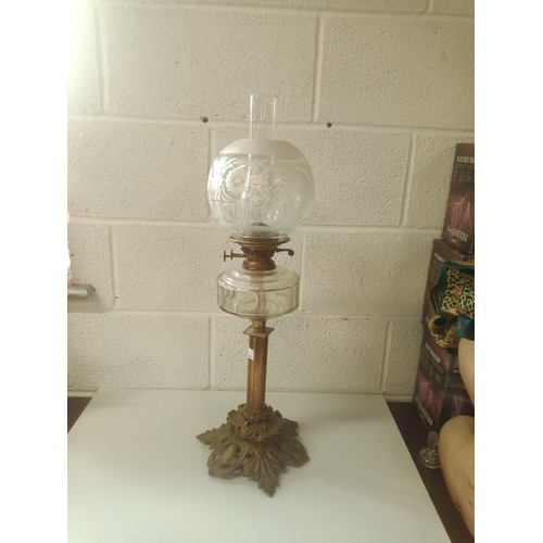 895 - Antique Brass & Glass Oil Lamp 71cm High. Slight Chip to the Glass Globe