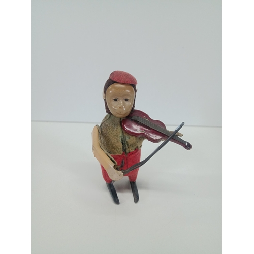 664 - A Vintage Schuco Clockwork Tin Toy Monkey playing a violin - Working