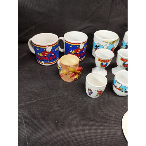 563 - A Collection of Rupert the Bear Mugs and Eggs Cups etc,