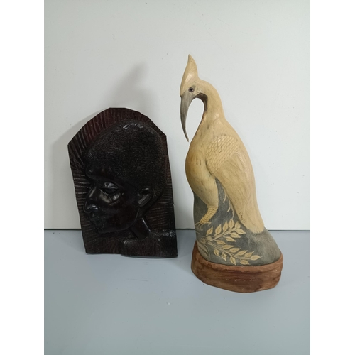 499 - A Carved Water Buffalo Horn Statue of an Egret or Heron and an African Ebonised Wood Carving