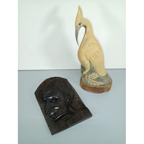 499 - A Carved Water Buffalo Horn Statue of an Egret or Heron and an African Ebonised Wood Carving