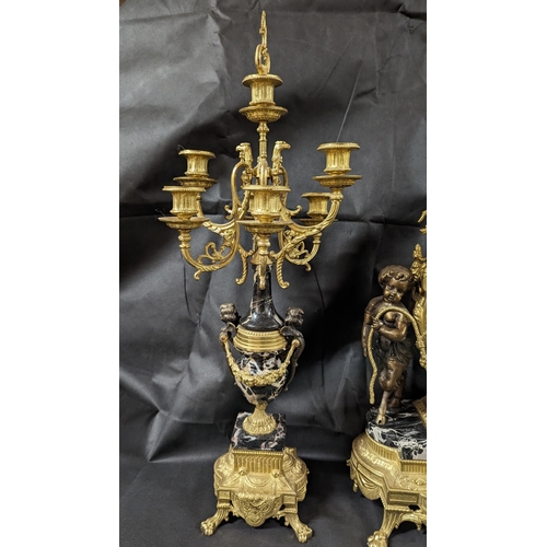 599 - An Italian Imperial Ormolu Triptych composed of Clock and Candelabra Garnitures in Bronze and Black ... 