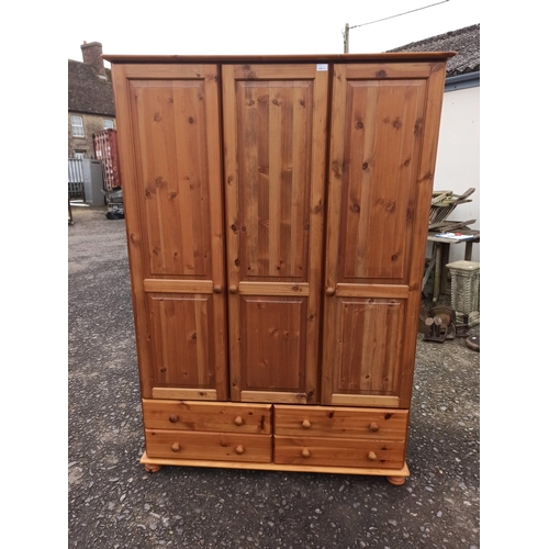 722 - A Triple Wardrobe With 4 Drawers.
186cm H x 130cm W x 58cm.