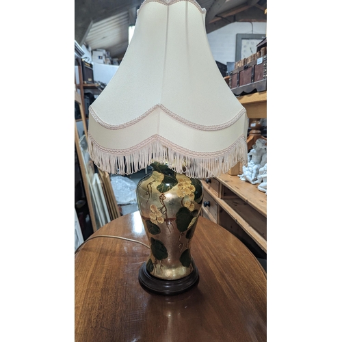 708 - A Table Lamp Decorated in Gold and Foliage 68cm