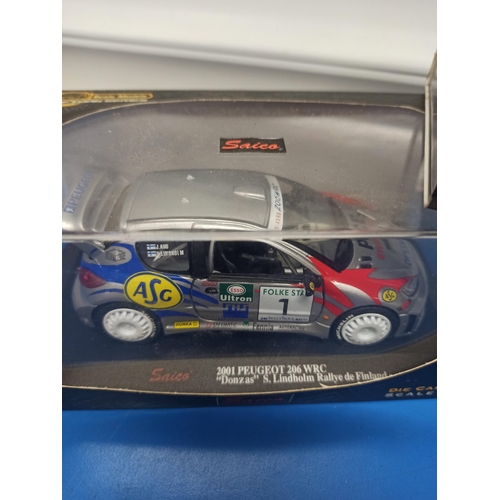 1224 - 3 x Boxed Saico Craftsman series WRC Cars, Including Peugeot 206, Citroen Xsara And Subaru Impreza.