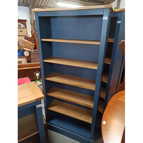 592 - A Tall Blue Painted Bookcase With Wooden Shelves.
180cm H x 85cm W x 28cm D.