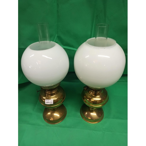 989 - A Pair of Brass Oil Lamps. Globe Glass Cracked On One Side As Pictured.