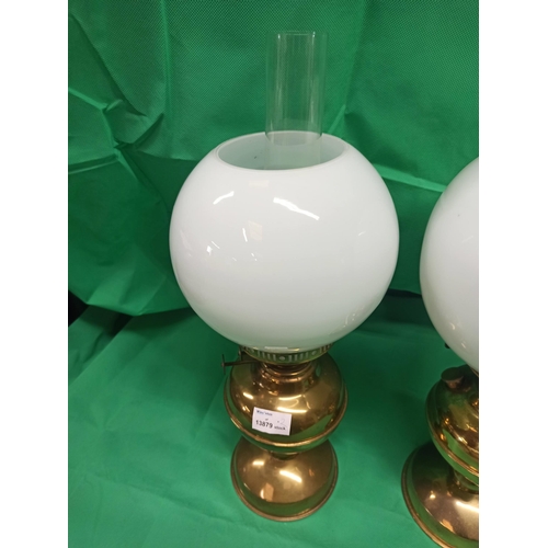 989 - A Pair of Brass Oil Lamps. Globe Glass Cracked On One Side As Pictured.