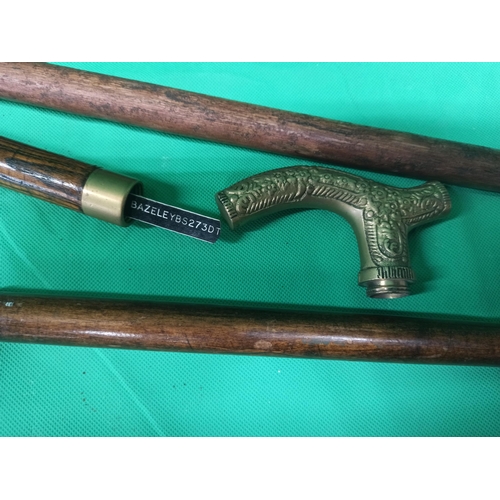 318 - A Pair Of Walking Sticks. One Has Duck Head Handle, The Other Sectional With Brass Handle.