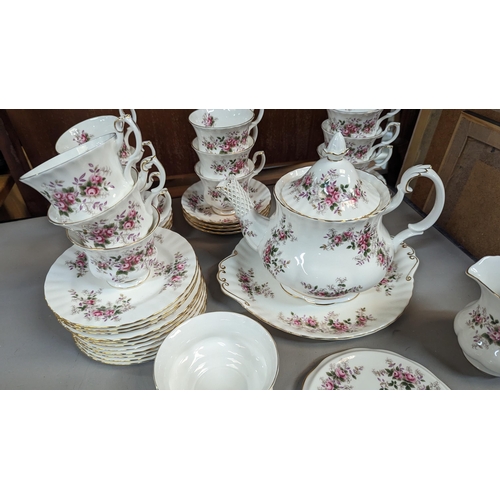 645 - A Royal Albert Lavender Rose Tea Service 12 x Cups, Saucers, Plates. Tea Pot, Milk Jug, Pot Stand, S... 