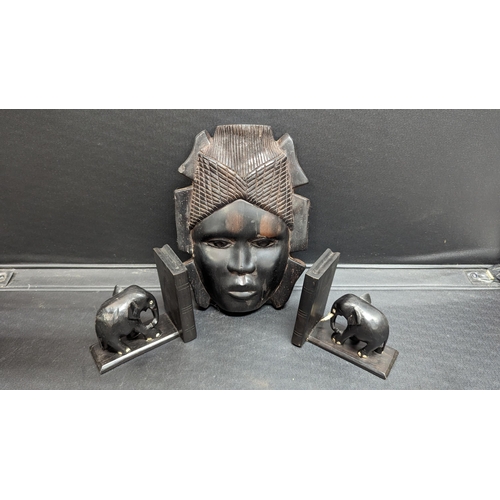 521 - An Ebonised African Masks with Elephant Book Ends