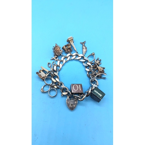 456 - A Heavy 88gm Silver Charm Bracelet including 10 Shilling Note and £1 Note