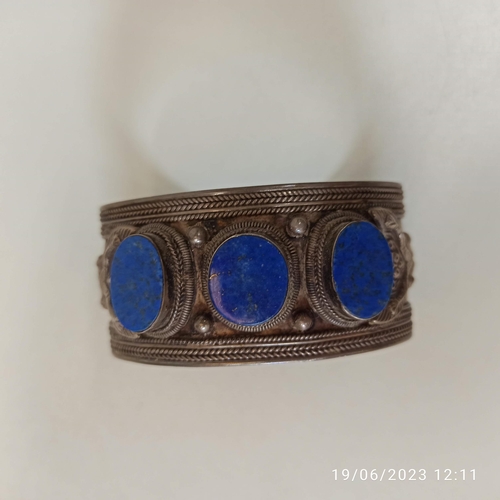 449 - A 925 Stamped Silver Lapis Lazuli Ethnic Bangle. Approx 60gms.