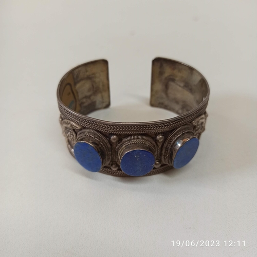 449 - A 925 Stamped Silver Lapis Lazuli Ethnic Bangle. Approx 60gms.