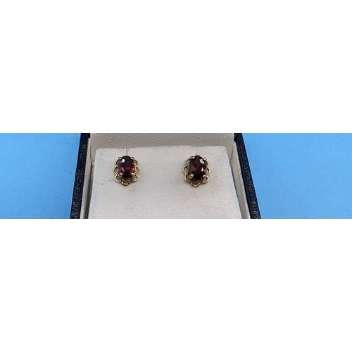 415 - A Pair of 9ct Gold and Garnet Earrings