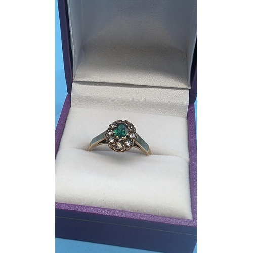 425 - A 9ct Emerald and White Stone Ring