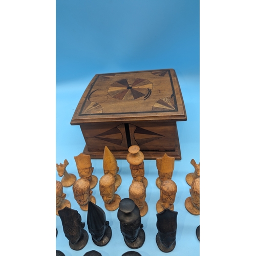 855 - Carved  African Head Chess Pieces in Puzzleware Wooden Box