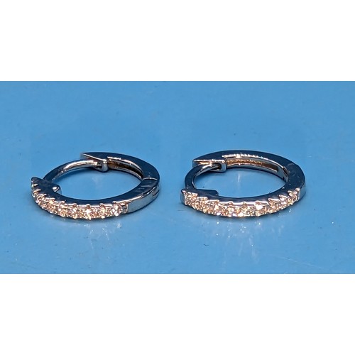 426 - A pair of cubic zirconia set hoop earrings