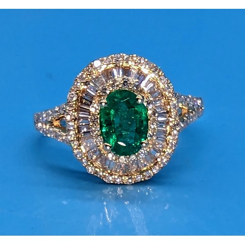 423 - 14ct yellow gold cluster ring set with oval emerald, baguette cut and round brilliant cut diamond wi... 