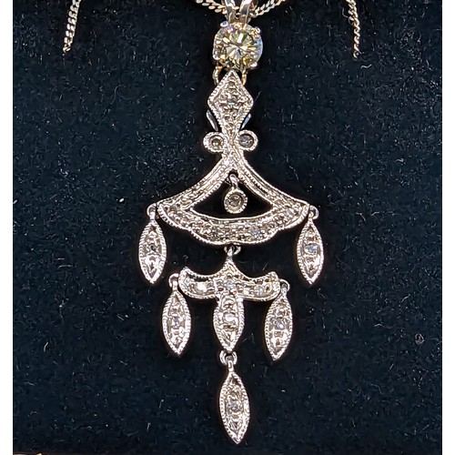 721 - 9ct white gold intricate pendant set with diamonds, on a 9ct white gold chain.  Diamonds approximate... 